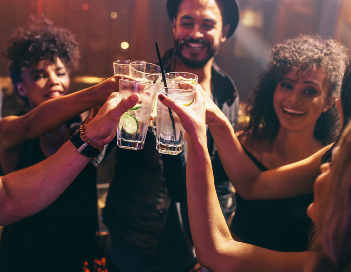 Friends out getting drinks and giving cheers