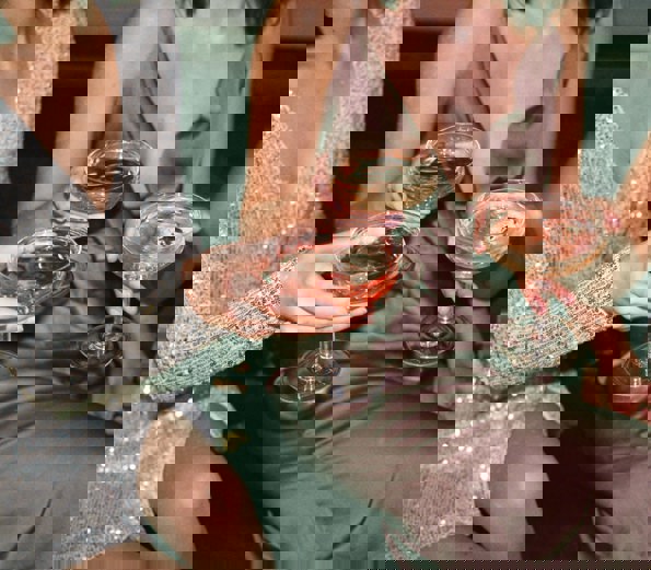 Women giving a cheers with close up of cocktails