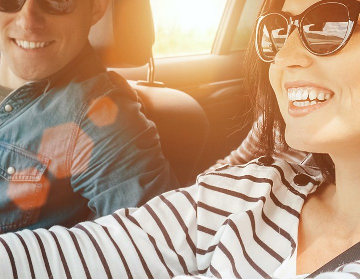 Friends smiling while driving in car