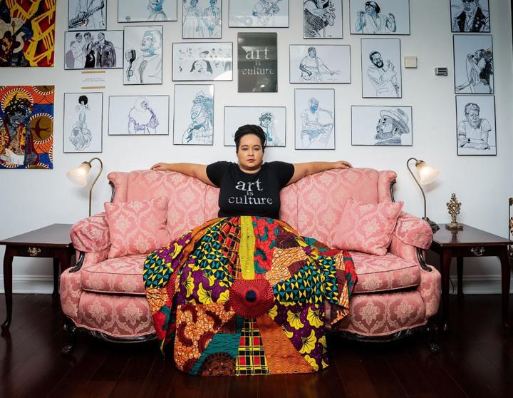 Rosy Petri on couch in front of artwork