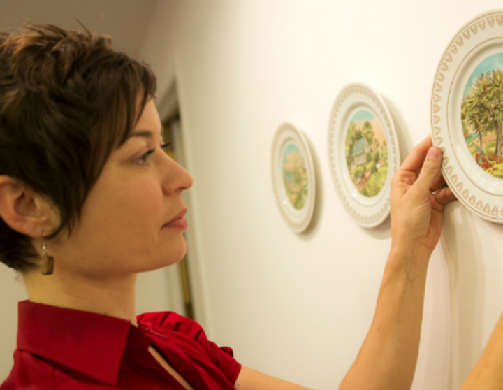 Niki Johnson artist hanging plates on a wall