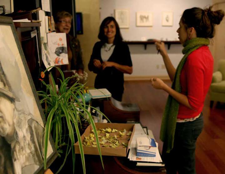 Katie Musolff artist in gallery space speaking to two ladies