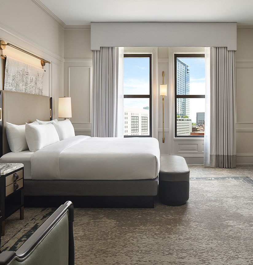 side shot of bedroom near window in hotel